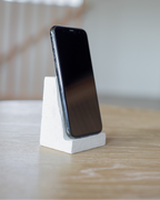 Smartphone on a white stand with a blurred background
